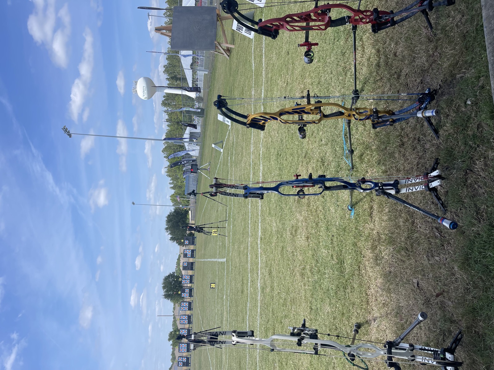 Compound bows on stands at the shooting line