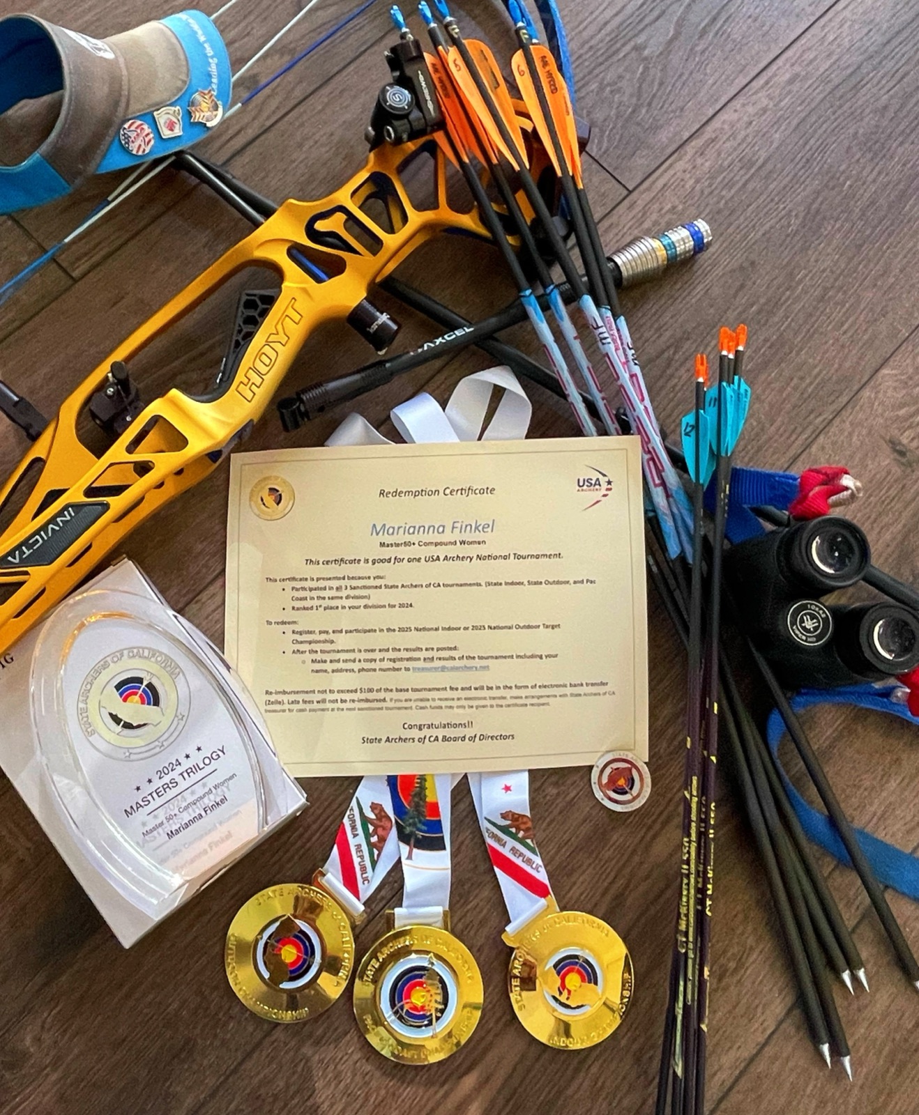 Competition bow, medals, and USA Archery national tournament certificate