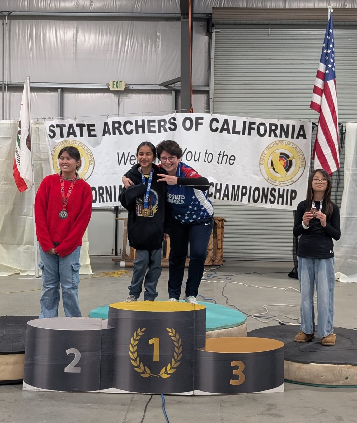 Young archery student on the top step of the State Archers of California championship podium