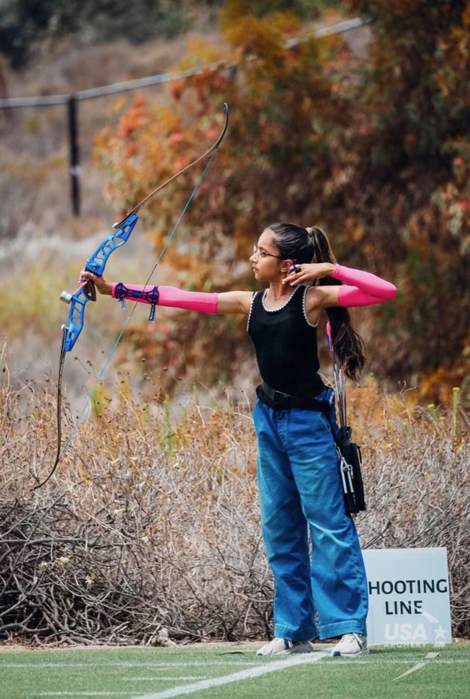 Young archery student at full draw on the shooting line